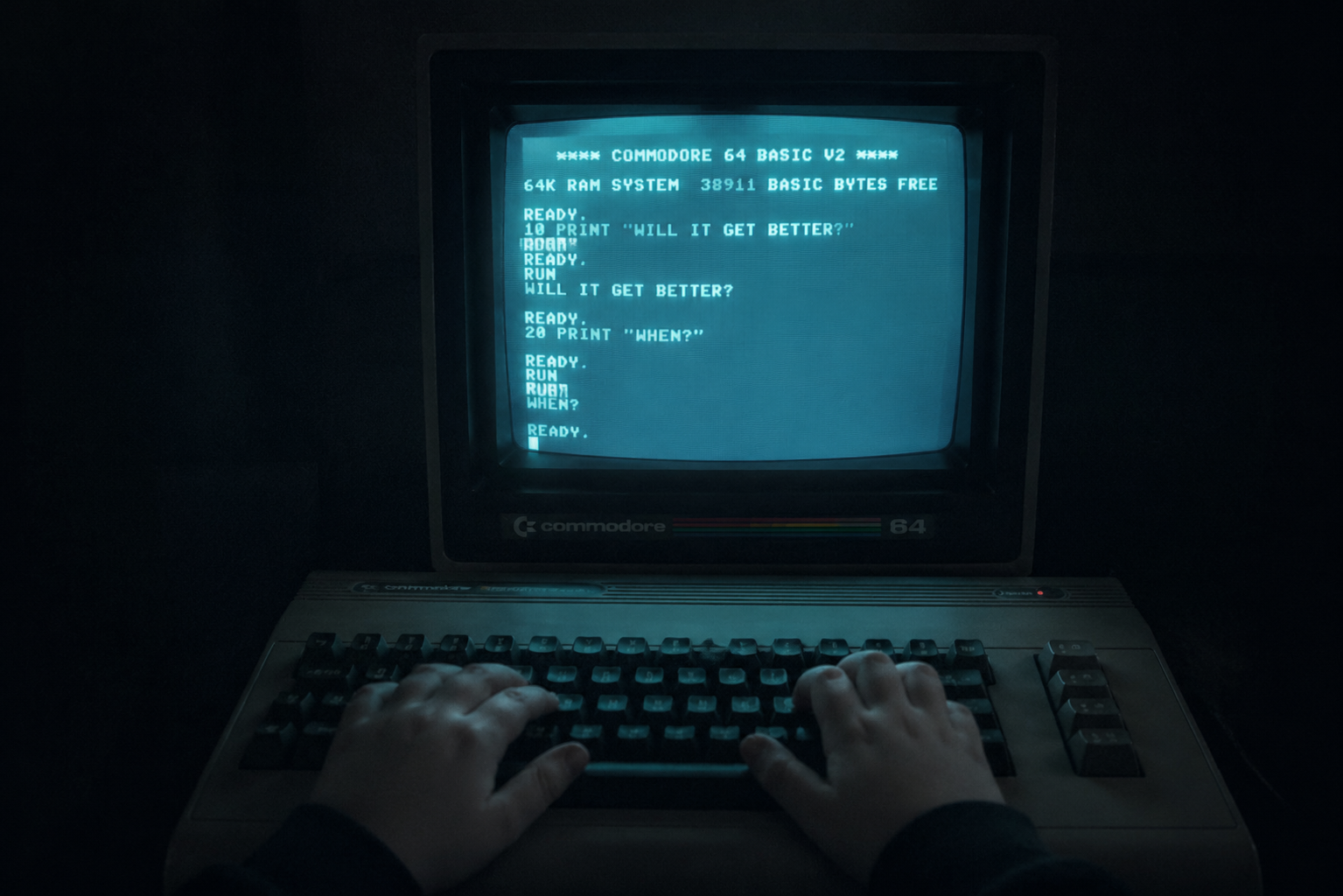 A Commodore 64 glowing in darkness — the beginning of a forty-year wait